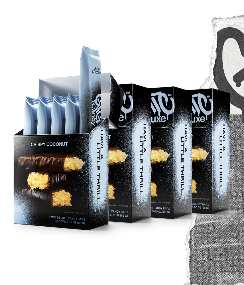 Four cartons of Gigantic Candy Deluxe in Crispy Coconut flavor, light blue and black colored packaging, with the front carton open to show 5 wrapped mini candy bars inside