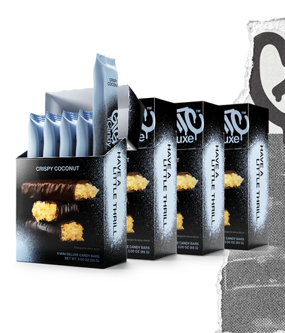 Four cartons of Gigantic Candy Deluxe in Crispy Coconut flavor, light blue and black colored packaging, with the front carton open to show 5 wrapped mini candy bars inside