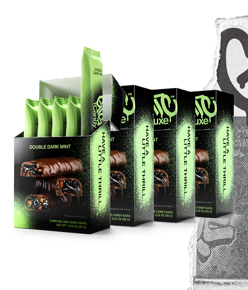 Four cartons of Gigantic Candy Deluxe in Double Dark Mint flavor, green and black colored packaging, with the front carton open to show 5 wrapped mini candy bars inside