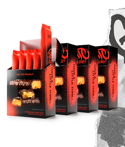 Four cartons of Gigantic Candy Deluxe in Salted Peanut flavor, red and black colored packaging, with the front carton open to show 5 wrapped mini candy bars inside